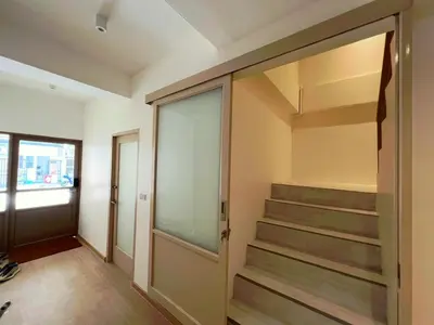 a walk in closet with a glass door and stairs at Slaap36 5BR Home with Parking, Walk to BTS Ari in Bangkok