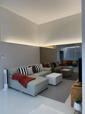 a living room with a couch and a tv at BaanChan House and Studio at Ramkhamhaeng in Ban Bang Toei (1)
