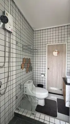 a bathroom with a toilet and a shower in it at BaanChan House and Studio at Ramkhamhaeng in Ban Bang Toei (1)