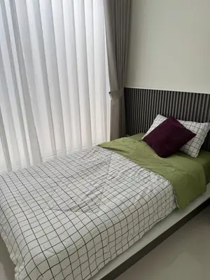 a bed in a bedroom with a window with blinds at BaanChan House and Studio at Ramkhamhaeng in Ban Bang Toei (1)