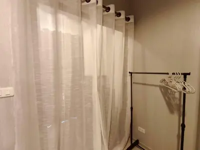 a white shower curtain in a bathroom with at Condo Studio Sukhumvit 115 BTS Pu Chao in Ban Khlong Samrong