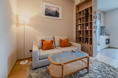 a living room with a couch and a table at 5 Star Centric 1BD Apartment Sukhumvit in Bangkok