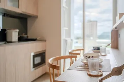 a kitchen with a table with chairs and a tableablish at 5 Star Centric 1BD Apartment Sukhumvit in Bangkok