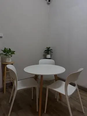 a white table and chairs in a room at Mango Rooms & Rooftop in Bangkok
