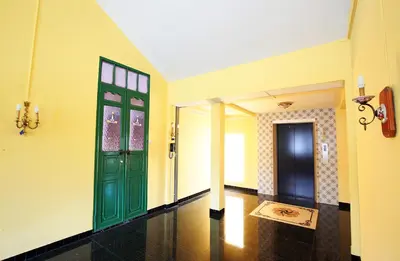 a hallway with a green door and a floor at The Myth - Sud Sathorn in Bangkok