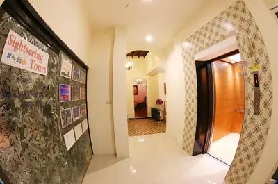 a hallway with a sign on a wall and a door at The Myth - Sud Sathorn in Bangkok