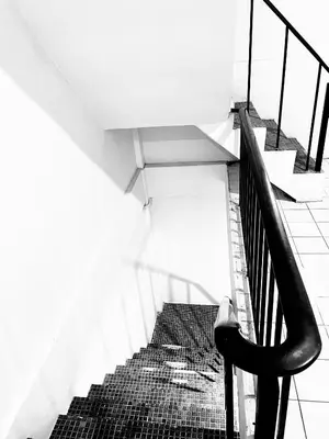 a black and white photo of a staircase in a building at Mitr Inn Khaosan Road - มิตรอินน์ ถนน ข้าวสาร in Bangkok