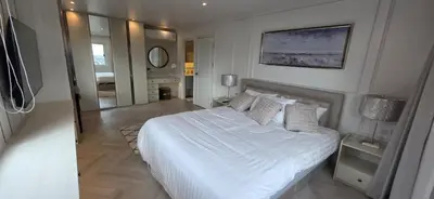 a bedroom with a large white bed and a mirror at Luxury Condo City Living R3 in Bangkok