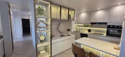 a kitchen with white cabinets and a counter top at Luxury Condo City Living R3 in Bangkok