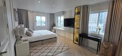 a bedroom with a bed and a desk and a television at Luxury Condo City Living R3 in Bangkok