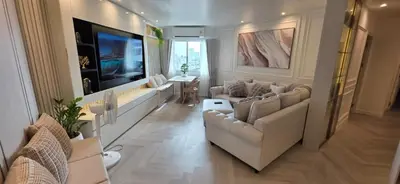 a living room with couches and a flat screen tv at Luxury Condo City Living R3 in Bangkok