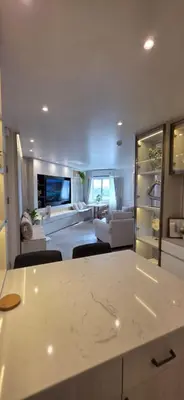 a kitchen and living room with a couch and a table at Luxury Condo City Living R3 in Bangkok