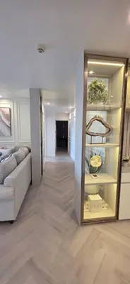 a living room with a couch and a mirror at Luxury Condo City Living R3 in Bangkok