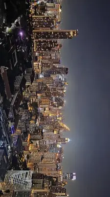 an aerial view of a tall building at night at City View Luxury Condo, AirportMRT link 50 meters in Bangkok