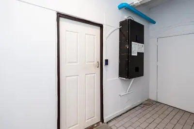 a white door in a room with a wall at XX The Hidden Khaosan Rambutri - เดอะ ฮิดเดน ข้าวสาร รามบุตรี xPro in Bangkok