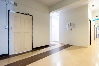 an empty room with a white door and a tile floor at XX The Hidden Khaosan Rambutri - เดอะ ฮิดเดน ข้าวสาร รามบุตรี xPro in Bangkok