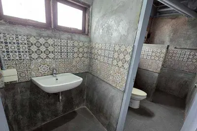 a bathroom with a sink and a toilet at Sukhum Huai Khwang Guest House in Bangkok