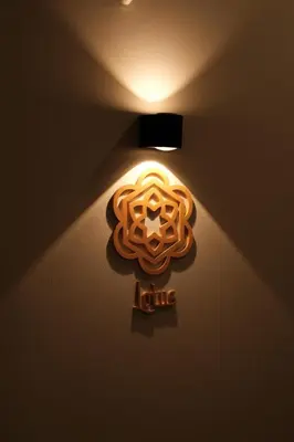 a light on a wall with a sign on it at The Shantipan Lotus - Cozy 2BR Family Stay 400m from BTS Station in Bangkok