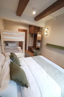a bedroom with two beds in a room at The Shantipan Lotus - Cozy 2BR Family Stay 400m from BTS Station in Bangkok