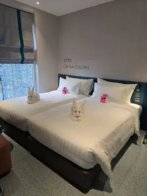 two beds with cats sitting on top of them at ARNI HER Ladies Hotel - Female Only in Bangkok