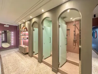 a walk in shower room with a row of glass doors at ARNI HER Ladies Hotel - Female Only in Bangkok
