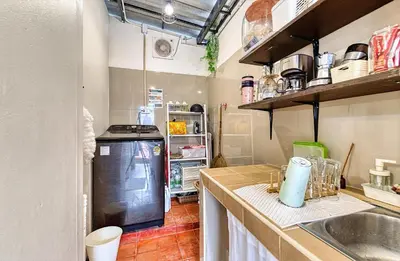 a small kitchen with a sink and a refrigerator at Cat House BKK in Bangkok