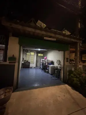 an empty garage at night with the door open at Homestay in Tha Akatsayan Don Muang