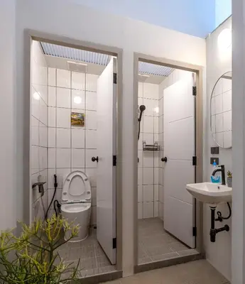 a bathroom with a toilet and a sink at MornSamyan in Bang Rak