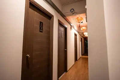 a hallway with a wooden door in a room at Soultel โซลเทล in Khlong San