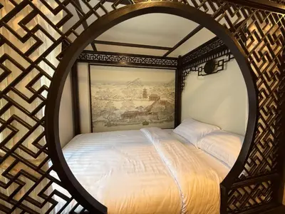 a bedroom with a large bed with a large mirror at Soultel โซลเทล in Khlong San