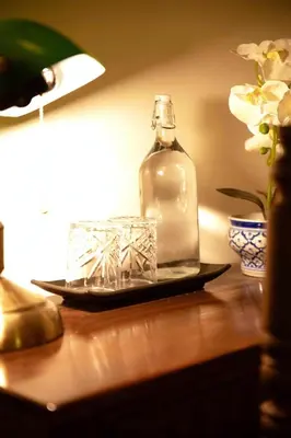a glass bottle sitting on top of a table at Casa Acero in Bangkok