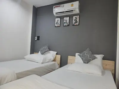a room with two beds and a heater on the wall at Sheikh Stay In Hostel in Bangkok