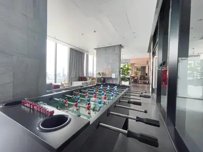 a room with a table with a game at Near BTS l Modern Luxury l By Sontana in Bangkok