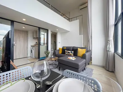 a living room with a couch and a table at Near BTS l Modern Luxury l By Sontana in Bangkok
