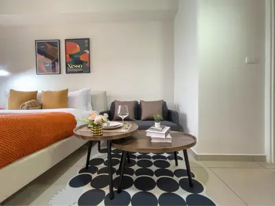 a living room with a bed and a coffee table at Walk to BTS Ekkamai l Urban Sukhumvit Living l Fast WiFi in Bangkok