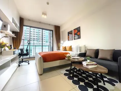 a living room with a bed and a couch at Walk to BTS Ekkamai l Urban Sukhumvit Living l Fast WiFi in Bangkok
