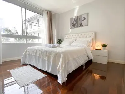 a white bedroom with a large bed and a window at Contemporary 53 SQM - BTS Thong Lo - Ultra Fast WiFi in Bangkok