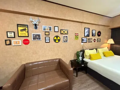 a hotel room with a bed and a couch at Secret Retro Vintage Building ห้องลับเรโทรในตึกวินเทจ in Ban Song Hong