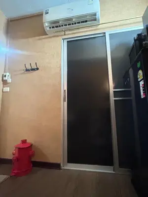 a fire hydrant in front of a sliding glass door at Secret Retro Vintage Building ห้องลับเรโทรในตึกวินเทจ in Ban Song Hong