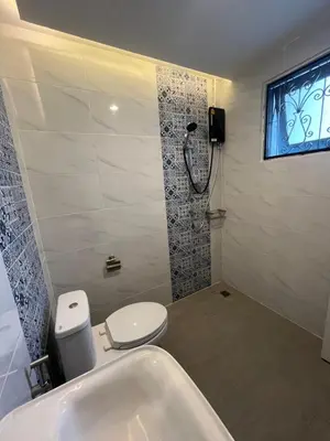 a bathroom with a shower and a toilet and a sink at Saen Saran property in Sathani Bang Ramat