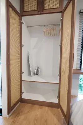 a walk in closet with a door open at The Shantipan Jasmine - Cozy City Retreat 400m from BTS Station in Bangkok