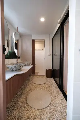 a bathroom with a sink and a mirror at The Shantipan Mandala - Cozy City Retreat 400m from BTS Station in Bangkok