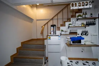 a kitchen with a refrigerator and a staircase at Pratunam Family House 2 in Bangkok
