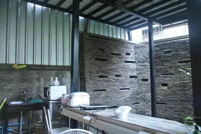 a kitchen with a counter and a brick wall at Eco House in Bangkok