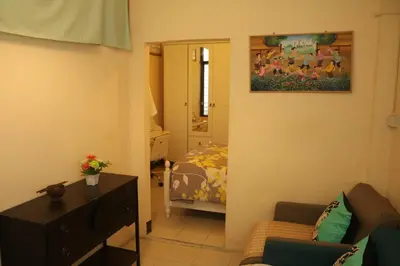 a small living room with a bed and a mirror at Eco House in Bangkok