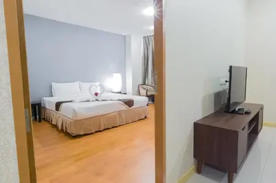 a hotel room with a bed and a television at Three Seasons Bangkok in Bangkok