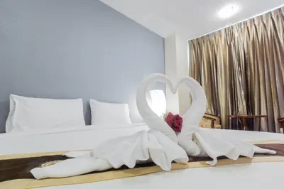 a bedroom with a bed with two white swans at Three Seasons Bangkok in Bangkok