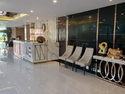a lobby with a group of chairs and a counter at Three Seasons Bangkok in Bangkok