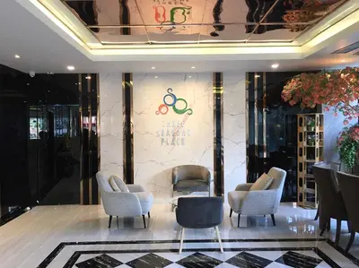 a lobby with chairs and a wall with the olympics at Three Seasons Bangkok in Bangkok