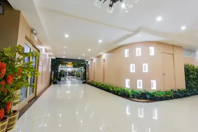an empty hallway of a building with plants at Three Seasons Bangkok in Bangkok